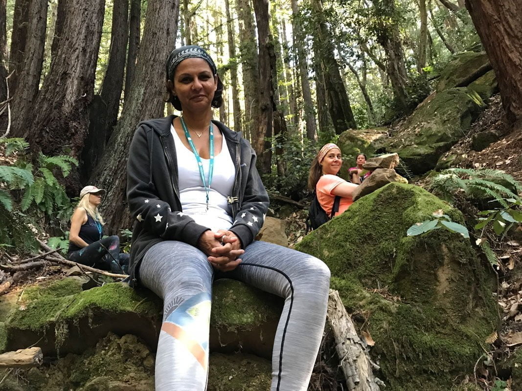 Ecotherapy group resting amond large trees